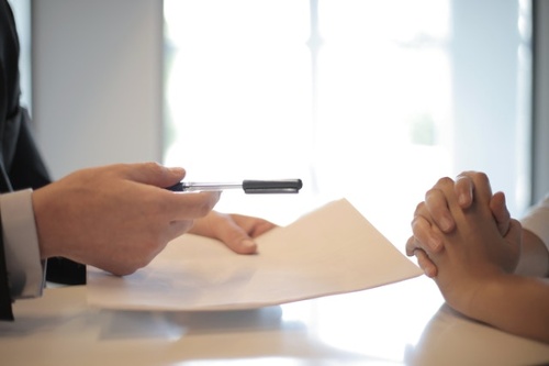 crop-businessman-giving-contract-to-woman-to-sign-3760067-1