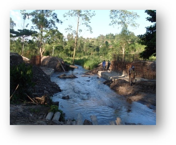 Nexus (U) Limited was entrusted with the construction of the Kanungu Bridge in Kanungu District, Uganda. This infrastructure project aimed to improve transportation, connectivity, and accessibility in the region, supporting economic development and improving the quality of life for local residents. Scope of the Construction Work The construction of Kanungu Bridge involved several key phases, from initial planning and design to final execution, with a focus on ensuring the bridge's structural integrity and longevity. Surveying and Design: The first phase of the project included detailed surveying of the site and designing a bridge structure that could withstand the region's environmental and traffic demands. The design process took into account local topography, hydrology, and soil conditions. Foundation Work: The foundation of the bridge was carefully designed to ensure stability and safety, with deep foundations constructed to support the weight of the bridge and the traffic it would carry. Bridge Deck and Superstructure: The bridge deck and superstructure were constructed using reinforced concrete and steel, materials chosen for their strength and durability. The deck was designed to accommodate vehicular traffic and pedestrian movement safely. Piling and Pier Construction: Strong and reliable piling and piers were built to ensure the bridge’s stability over the water and provide resistance to environmental factors like flooding and erosion. Approach Roads and Pavement: Nexus (U) Limited constructed the approach roads leading to the bridge, ensuring smooth connectivity with existing road networks. Proper paving and road signage were included for safe travel. Safety and Security Features: Safety railings, guardrails, and other protective measures were installed to ensure the safety of drivers and pedestrians. Proper signage and lighting were also added to enhance visibility, especially during the night. Environmental Considerations: Throughout the construction, Nexus (U) Limited implemented environmentally responsible practices, ensuring minimal disruption to local wildlife and ecosystems during the building process. Final Inspection and Testing: After construction was completed, the bridge was thoroughly inspected to ensure compliance with safety and quality standards. Load testing and other necessary assessments were conducted before the official opening. Benefits of the Kanungu Bridge Improved Accessibility: The completion of Kanungu Bridge has greatly improved transportation across the district, reducing travel time and connecting rural communities to nearby towns and cities. Economic Development: The bridge facilitates easier access to markets, services, and resources, benefiting local farmers, businesses, and residents. Enhanced Safety: The new bridge has provided a safer alternative to previous crossing methods, especially during rainy seasons when flooding and erosion were common concerns. Community Connectivity: The bridge plays a crucial role in connecting Kanungu District to other parts of Uganda, promoting regional integration and supporting infrastructure development. Completion and Outcome The Kanungu Bridge was successfully completed, with Nexus (U) Limited ensuring high standards of construction quality, safety, and environmental sustainability. The bridge now stands as a vital infrastructure asset, providing lasting benefits to the local community and supporting the broader development objectives of the region.