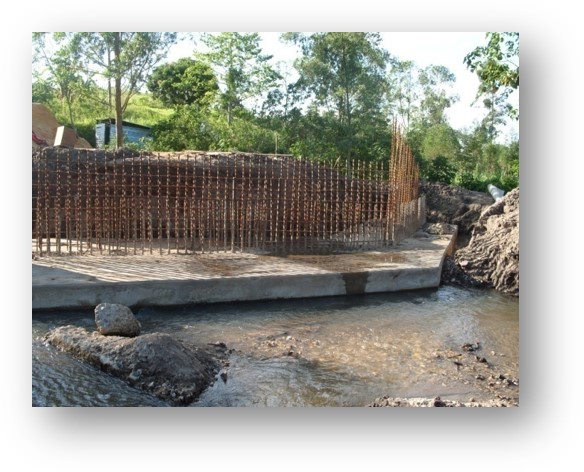 Nexus (U) Limited was entrusted with the construction of the Kanungu Bridge in Kanungu District, Uganda. This infrastructure project aimed to improve transportation, connectivity, and accessibility in the region, supporting economic development and improving the quality of life for local residents. Scope of the Construction Work The construction of Kanungu Bridge involved several key phases, from initial planning and design to final execution, with a focus on ensuring the bridge's structural integrity and longevity. Surveying and Design: The first phase of the project included detailed surveying of the site and designing a bridge structure that could withstand the region's environmental and traffic demands. The design process took into account local topography, hydrology, and soil conditions. Foundation Work: The foundation of the bridge was carefully designed to ensure stability and safety, with deep foundations constructed to support the weight of the bridge and the traffic it would carry. Bridge Deck and Superstructure: The bridge deck and superstructure were constructed using reinforced concrete and steel, materials chosen for their strength and durability. The deck was designed to accommodate vehicular traffic and pedestrian movement safely. Piling and Pier Construction: Strong and reliable piling and piers were built to ensure the bridge’s stability over the water and provide resistance to environmental factors like flooding and erosion. Approach Roads and Pavement: Nexus (U) Limited constructed the approach roads leading to the bridge, ensuring smooth connectivity with existing road networks. Proper paving and road signage were included for safe travel. Safety and Security Features: Safety railings, guardrails, and other protective measures were installed to ensure the safety of drivers and pedestrians. Proper signage and lighting were also added to enhance visibility, especially during the night. Environmental Considerations: Throughout the construction, Nexus (U) Limited implemented environmentally responsible practices, ensuring minimal disruption to local wildlife and ecosystems during the building process. Final Inspection and Testing: After construction was completed, the bridge was thoroughly inspected to ensure compliance with safety and quality standards. Load testing and other necessary assessments were conducted before the official opening. Benefits of the Kanungu Bridge Improved Accessibility: The completion of Kanungu Bridge has greatly improved transportation across the district, reducing travel time and connecting rural communities to nearby towns and cities. Economic Development: The bridge facilitates easier access to markets, services, and resources, benefiting local farmers, businesses, and residents. Enhanced Safety: The new bridge has provided a safer alternative to previous crossing methods, especially during rainy seasons when flooding and erosion were common concerns. Community Connectivity: The bridge plays a crucial role in connecting Kanungu District to other parts of Uganda, promoting regional integration and supporting infrastructure development. Completion and Outcome The Kanungu Bridge was successfully completed, with Nexus (U) Limited ensuring high standards of construction quality, safety, and environmental sustainability. The bridge now stands as a vital infrastructure asset, providing lasting benefits to the local community and supporting the broader development objectives of the region.