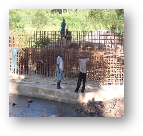 Nexus (U) Limited was entrusted with the construction of the Kanungu Bridge in Kanungu District, Uganda. This infrastructure project aimed to improve transportation, connectivity, and accessibility in the region, supporting economic development and improving the quality of life for local residents. Scope of the Construction Work The construction of Kanungu Bridge involved several key phases, from initial planning and design to final execution, with a focus on ensuring the bridge's structural integrity and longevity. Surveying and Design: The first phase of the project included detailed surveying of the site and designing a bridge structure that could withstand the region's environmental and traffic demands. The design process took into account local topography, hydrology, and soil conditions. Foundation Work: The foundation of the bridge was carefully designed to ensure stability and safety, with deep foundations constructed to support the weight of the bridge and the traffic it would carry. Bridge Deck and Superstructure: The bridge deck and superstructure were constructed using reinforced concrete and steel, materials chosen for their strength and durability. The deck was designed to accommodate vehicular traffic and pedestrian movement safely. Piling and Pier Construction: Strong and reliable piling and piers were built to ensure the bridge’s stability over the water and provide resistance to environmental factors like flooding and erosion. Approach Roads and Pavement: Nexus (U) Limited constructed the approach roads leading to the bridge, ensuring smooth connectivity with existing road networks. Proper paving and road signage were included for safe travel. Safety and Security Features: Safety railings, guardrails, and other protective measures were installed to ensure the safety of drivers and pedestrians. Proper signage and lighting were also added to enhance visibility, especially during the night. Environmental Considerations: Throughout the construction, Nexus (U) Limited implemented environmentally responsible practices, ensuring minimal disruption to local wildlife and ecosystems during the building process. Final Inspection and Testing: After construction was completed, the bridge was thoroughly inspected to ensure compliance with safety and quality standards. Load testing and other necessary assessments were conducted before the official opening. Benefits of the Kanungu Bridge Improved Accessibility: The completion of Kanungu Bridge has greatly improved transportation across the district, reducing travel time and connecting rural communities to nearby towns and cities. Economic Development: The bridge facilitates easier access to markets, services, and resources, benefiting local farmers, businesses, and residents. Enhanced Safety: The new bridge has provided a safer alternative to previous crossing methods, especially during rainy seasons when flooding and erosion were common concerns. Community Connectivity: The bridge plays a crucial role in connecting Kanungu District to other parts of Uganda, promoting regional integration and supporting infrastructure development. Completion and Outcome The Kanungu Bridge was successfully completed, with Nexus (U) Limited ensuring high standards of construction quality, safety, and environmental sustainability. The bridge now stands as a vital infrastructure asset, providing lasting benefits to the local community and supporting the broader development objectives of the region.